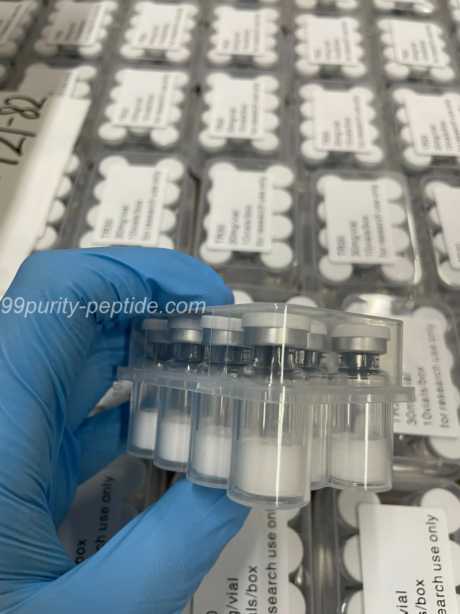 Handheld HMG 75iu vial at 99Purity-Peptide warehouse, showcasing authentic pct stock.