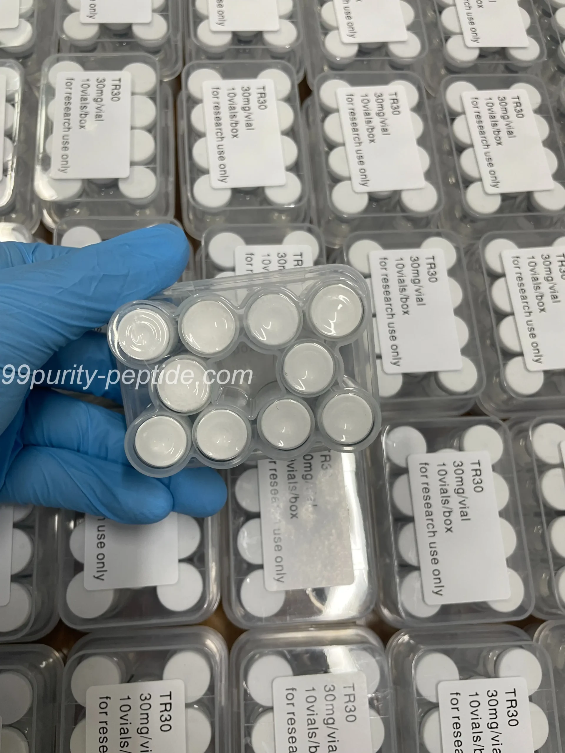 Handheld Retatrutide 60mg vial in 99Purity-Peptide warehouse, ready for weight research shipping.